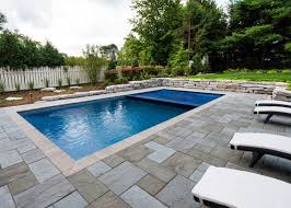 Rectangular backyard pool with stone patio