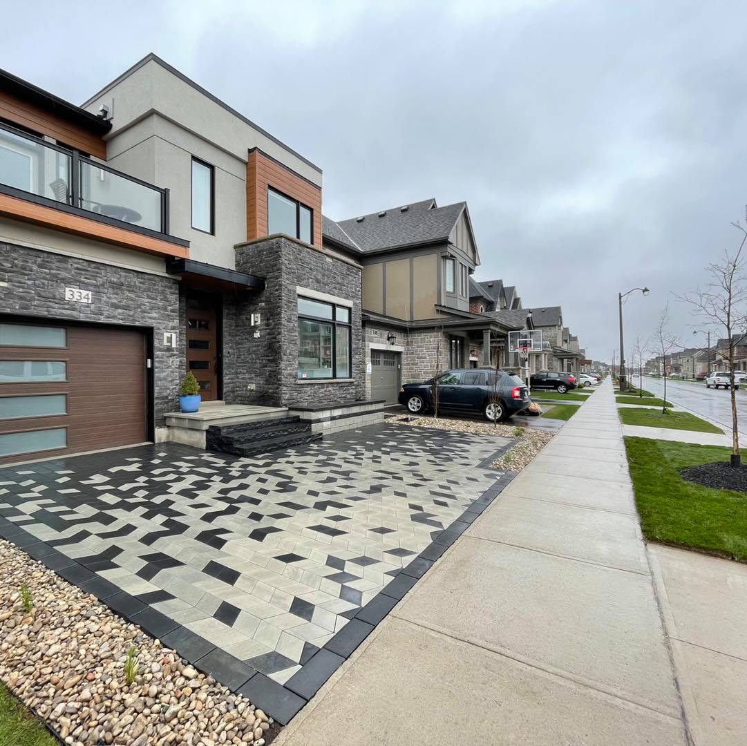 Stone clad facade and patterned driveway