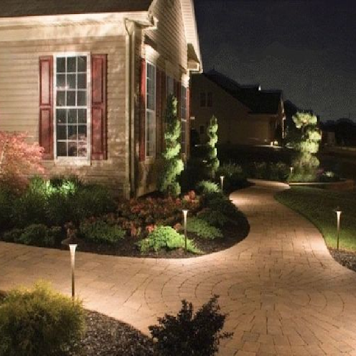 Illuminated curved brick walkway at night